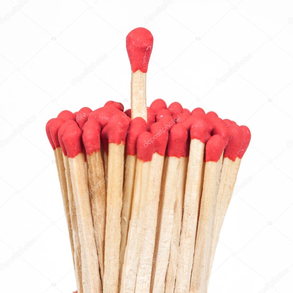 One matchstick standing over from the group, leader concept