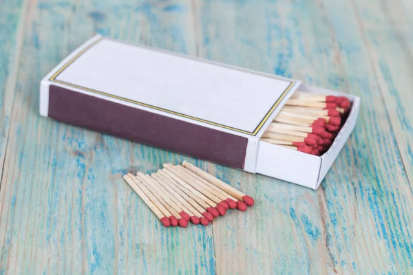 Caja de cerillas roja sobre fondo de madera de color —  Fotos de Stock