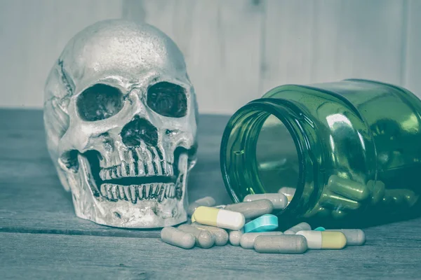 Human skull with drugs on wood — Stock Photo, Image