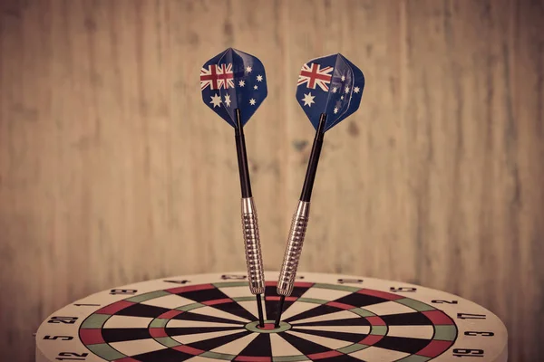 Darts arrow with Australia flags on red dart board