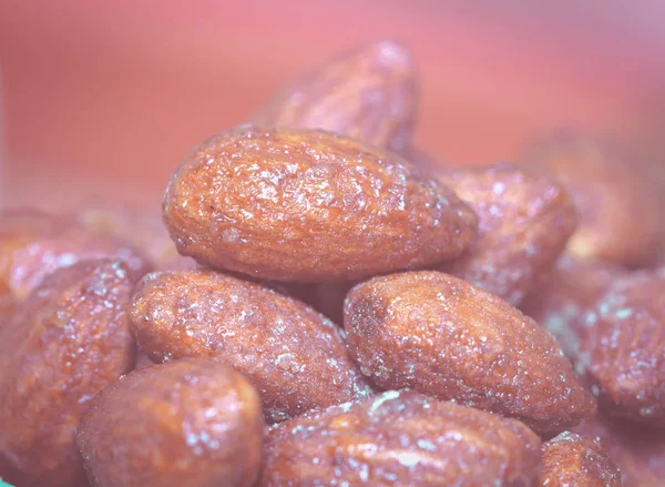 Almonds caramel  in cup on table. Selective focus, shallow DOF