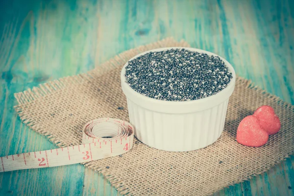 Chia seeds in bowl with measuring tape. — Stock Photo, Image