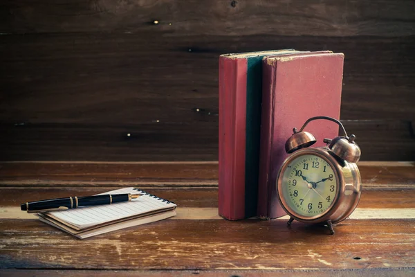 Still life alarm clock on old book — Stock Photo, Image
