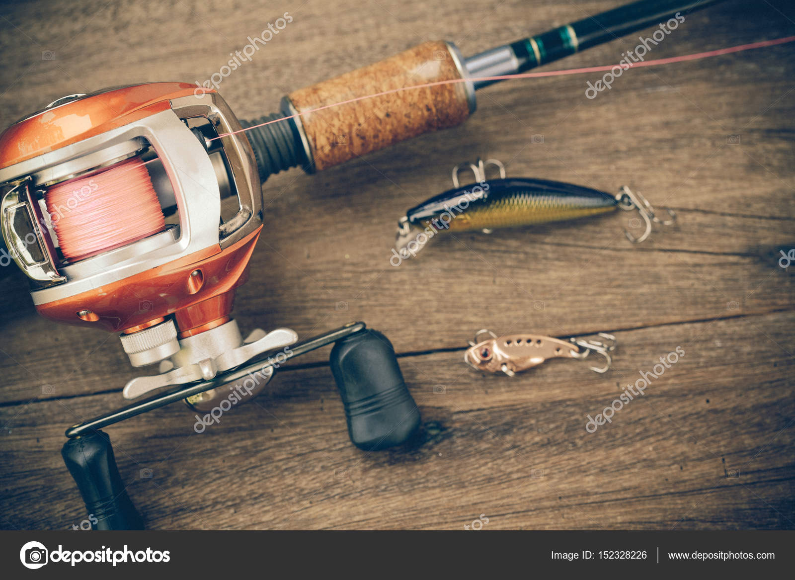 Fishing tackle - Baitcasting Reel, hooks and lures on wooden ba Stock Photo  by ©amnarj20066 152328226