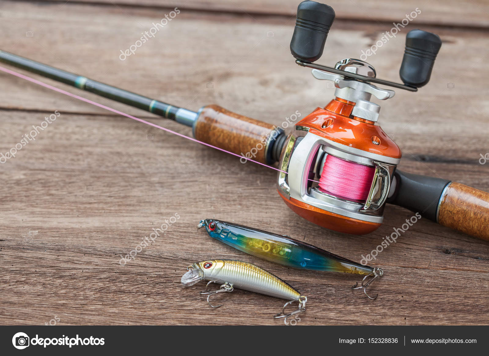 Fishing tackle - Baitcasting Reel, hooks and lures on wooden ba Stock Photo  by ©amnarj20066 152328836