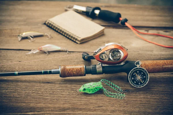 Fishing tackle - Baitcasting Reel, hooks and lures on  wooden ba — Stock Photo, Image