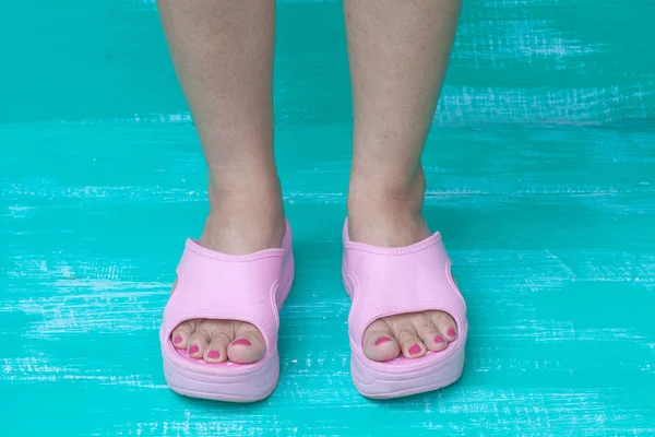 Lady feet on color wood — стоковое фото