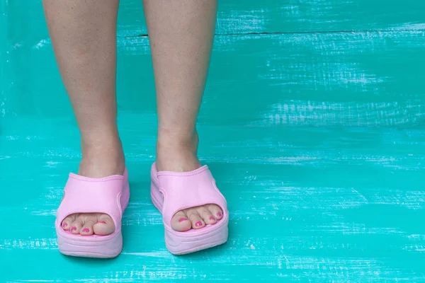 Lady feet on color wood — стоковое фото