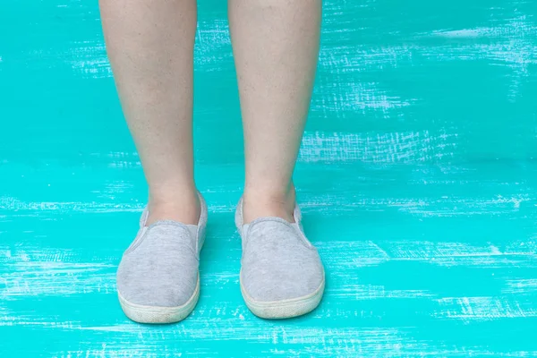 Lady feet on color wood — стоковое фото