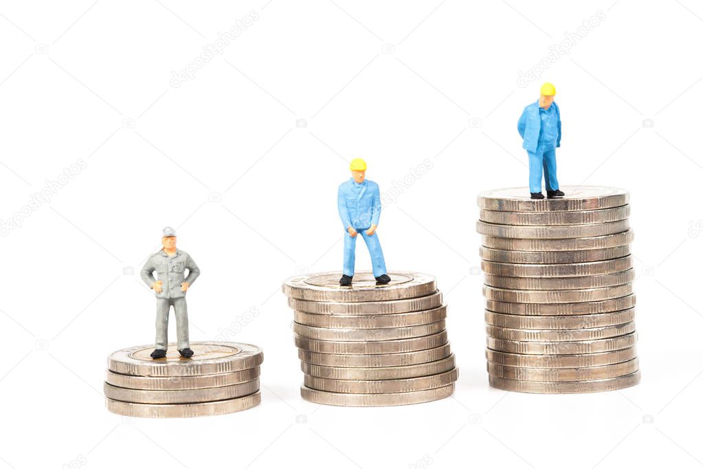 miniature worker with coin stack