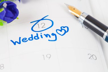 Düğün Not takvimdeki bir hatırlatma çiçek ve kalem ile düğün günü için ayarlar