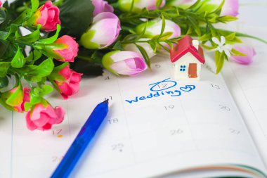 Düğün Not takvimdeki bir hatırlatma çiçek ve kalem ile düğün günü için ayarlar