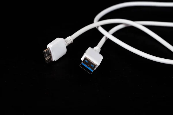 White charger cable on black background — Stock Photo, Image