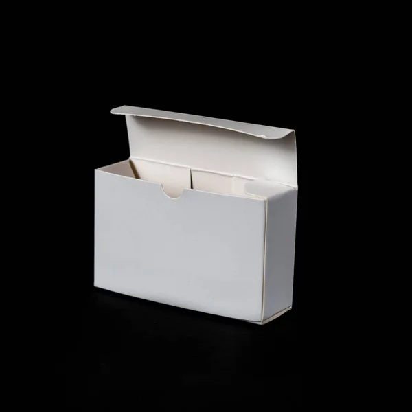 White paper box on black background — Stock Photo, Image