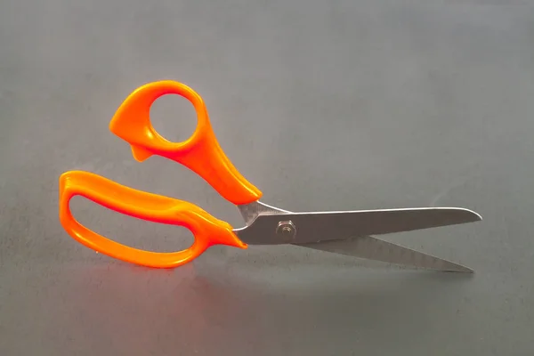 Orance holder of scissors on background — Stock Photo, Image