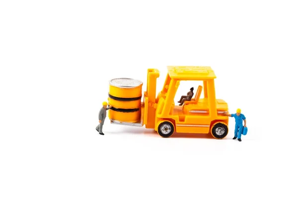 Miniature worker and small forklift on white background — Stock Photo, Image