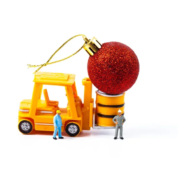 Miniature worker and small forklift with christmas ball — Stock Photo, Image