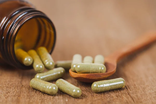 Herbal Medicine Capsules Spilling Out Bottle Soft Focus — Stock Photo, Image