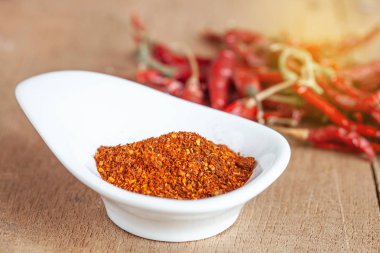 Acı biber beyaz tabak ve ahşap masa üzerinde kurutulmuş biber