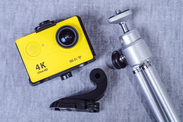 Yellow Action camera on cloth texture background.