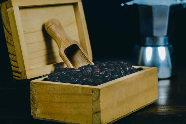 Coffee bean in wood box on old wood background.