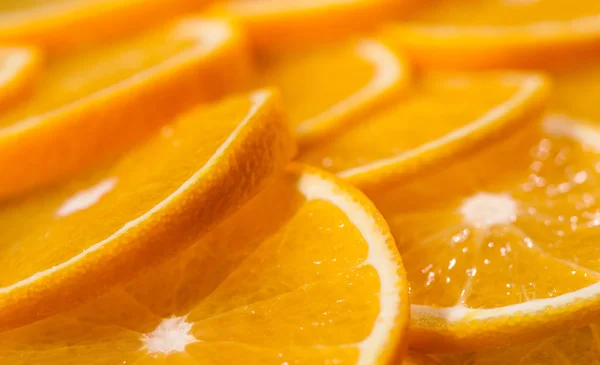 Juicy oranges sliced and arranged in rows