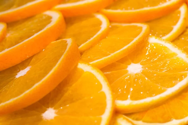 Juicy oranges sliced and arranged in rows