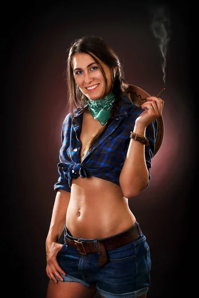 Smoking cowgirl studio portrait — Stock Photo, Image