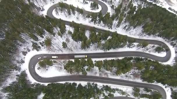 Flying over mountain road pass with traffic , in winter — Stock Video