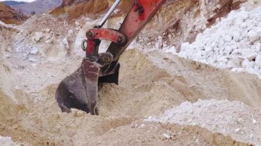 Kazıcı kamyona ağır çekimde kum yüklüyor. İnşaat malzemesi.