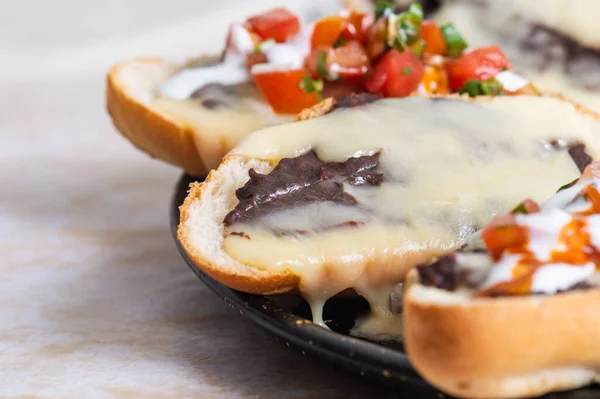 Köstebekler. Vejetaryen Meksika yemekleri bruschetta 'ya benzer. Kızarmış fasulye ve erimiş peynir..