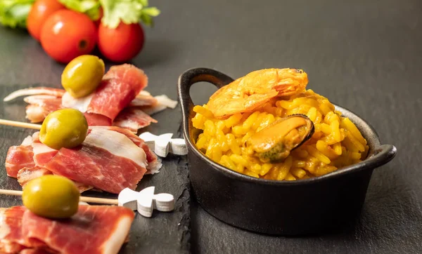 Spanish tapas, Iberian ham, Valencian paella and olives — стокове фото