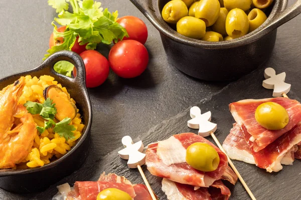 Spanish tapas, Iberian ham, Valencian paella and olives — Stock Photo, Image