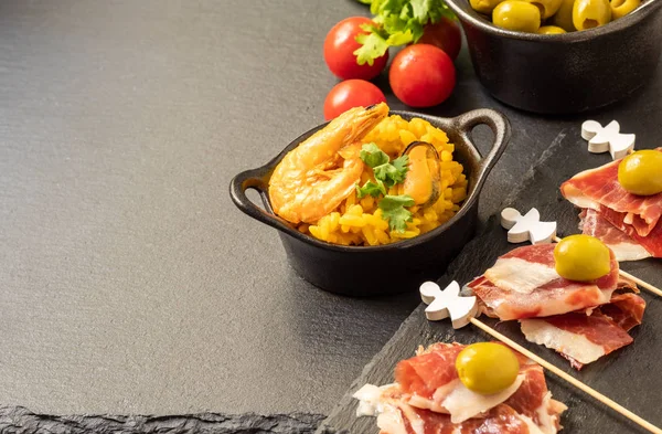 Spanish tapas, Iberian ham, Valencian paella and olives — стокове фото