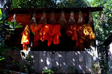 View of a hut and robes of Buddhist monks