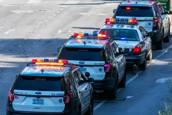 Multiple Las Vegas Metropolitan Police Department Lvmpd vehicles patterling The Strip with light bar flashing — стокове фото