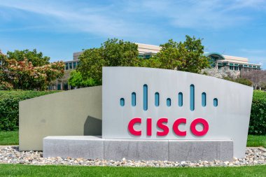 Cisco, Silikon Vadisi 'ndeki Cisco merkez kampüsünün yakınlarında imza atmış. Kırmızı ve mavi logo, Golden Gate Köprüsü 'nün iki kulesini gösteriyor.