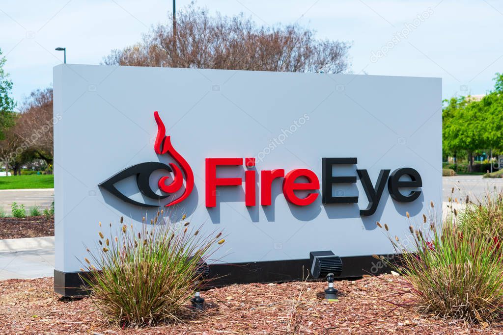 FireEye logo is displayed near cybersecurity company campus headquartered in Silicon Valley - Milpitas, California, USA - April 7, 2019