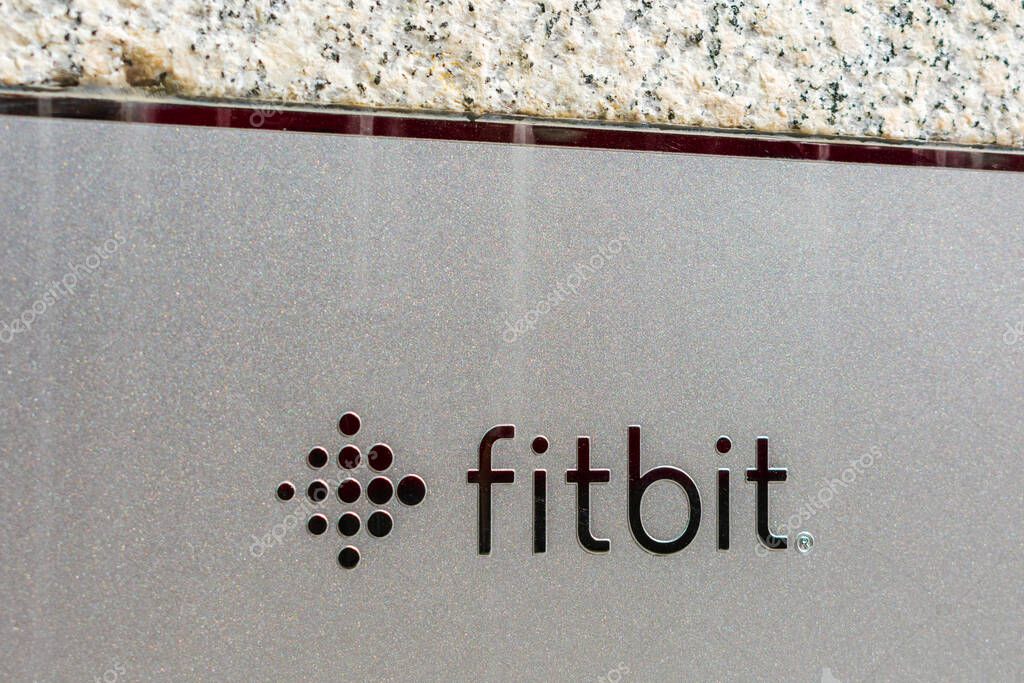 Fitbit sign on HQ facade. Fitbit, Inc. is an American company that produces wireless-enabled wearable technology devices for activity tracking - San Francisco, California, USA - 2020