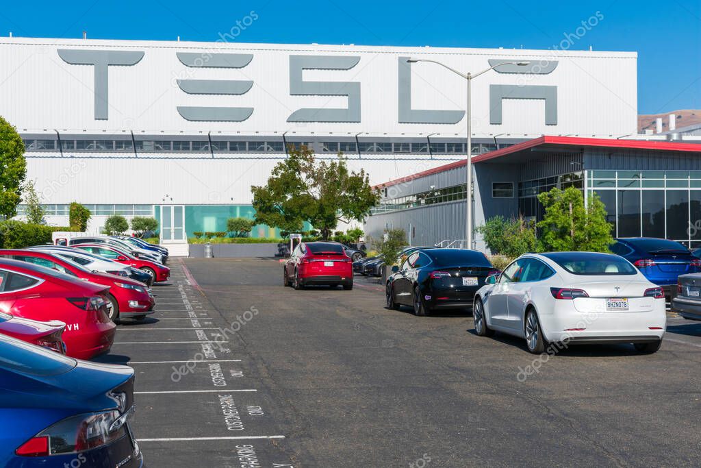 Tesla logo displayed on the exterior wall of Tesla Factory, automobile manufacturing plant in Silicon Valley - Fremont, CA, USA - 2019