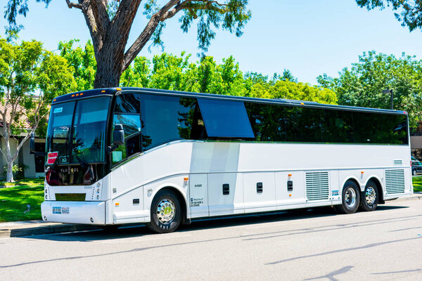 An empty shuttle bus made by Van Hool waits for passengers. Silicon Valley high-tech companies often provide a commuter service for the employees - Mountain View, California, USA - 2019