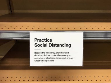 Practice Social Distancing sign one the empty shelves in a supermarket requesting customers to maintain a distance of at least 6 feet in order to prevent spread of a highly contagious disease COVID-19 clipart