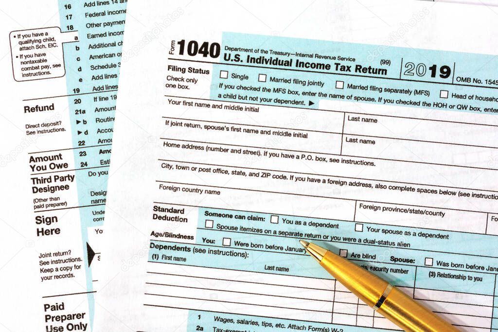 Form 1040, U.S. Individual Income Tax Return 2019 with golden ballpoint pen