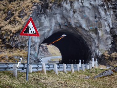 Road sign and tunnel in mountains in Bleik, Nordland county, Norway, Europe clipart