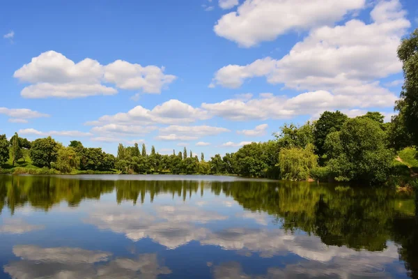 Blue sky reflection in the lake at summer sunny day. Beautiful clouds reflection. Countryside day. Fresh air. Countryside lake.