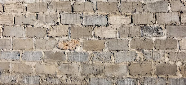 Texture of a concrete block wall. Grunge texture of concrete blocks for designers. Block of rough masonry.