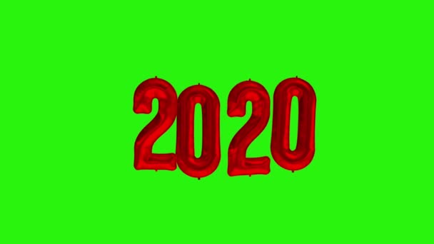 Святкування Нового 2020 року. Кульки червоної фольги цифра 2020 на зеленому фоні — стокове відео