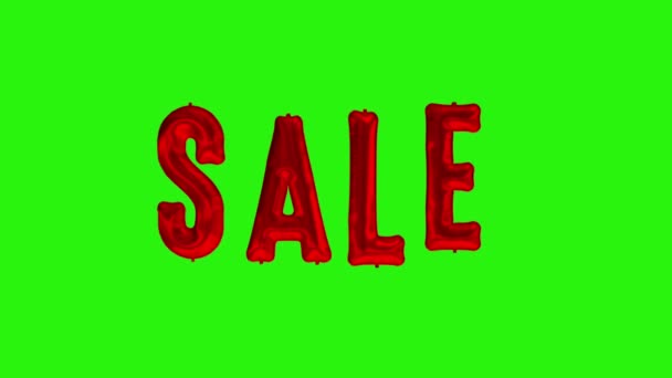 Schwimmende Buchstaben Verkauf aus roter Folie Ballon auf grünem Hintergrund — Stockvideo