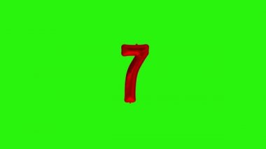 Yedi numara, yedinci yıl kutlama kırmızı folyo balonu yeşil üzerinde yüzüyor.