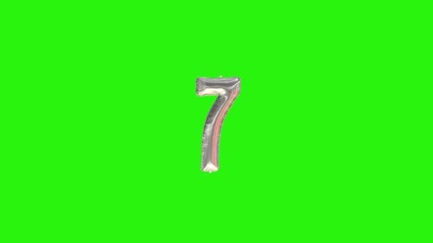 Number 7 seven seventh year celebration silver foil balloon floating on green — Stock Video